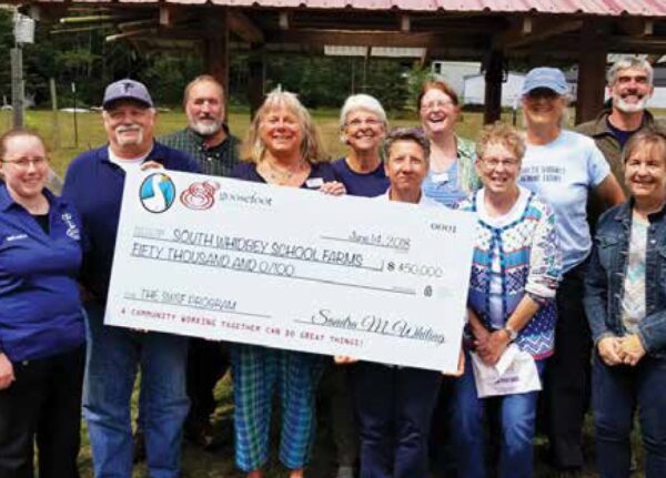 A group holds an oversized grant check from the Goosefoot foundation
