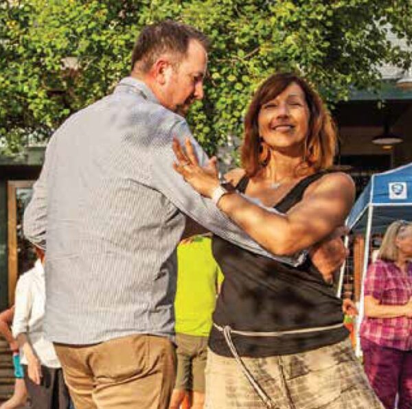 A couple dances at a street festival on Whidbey Island