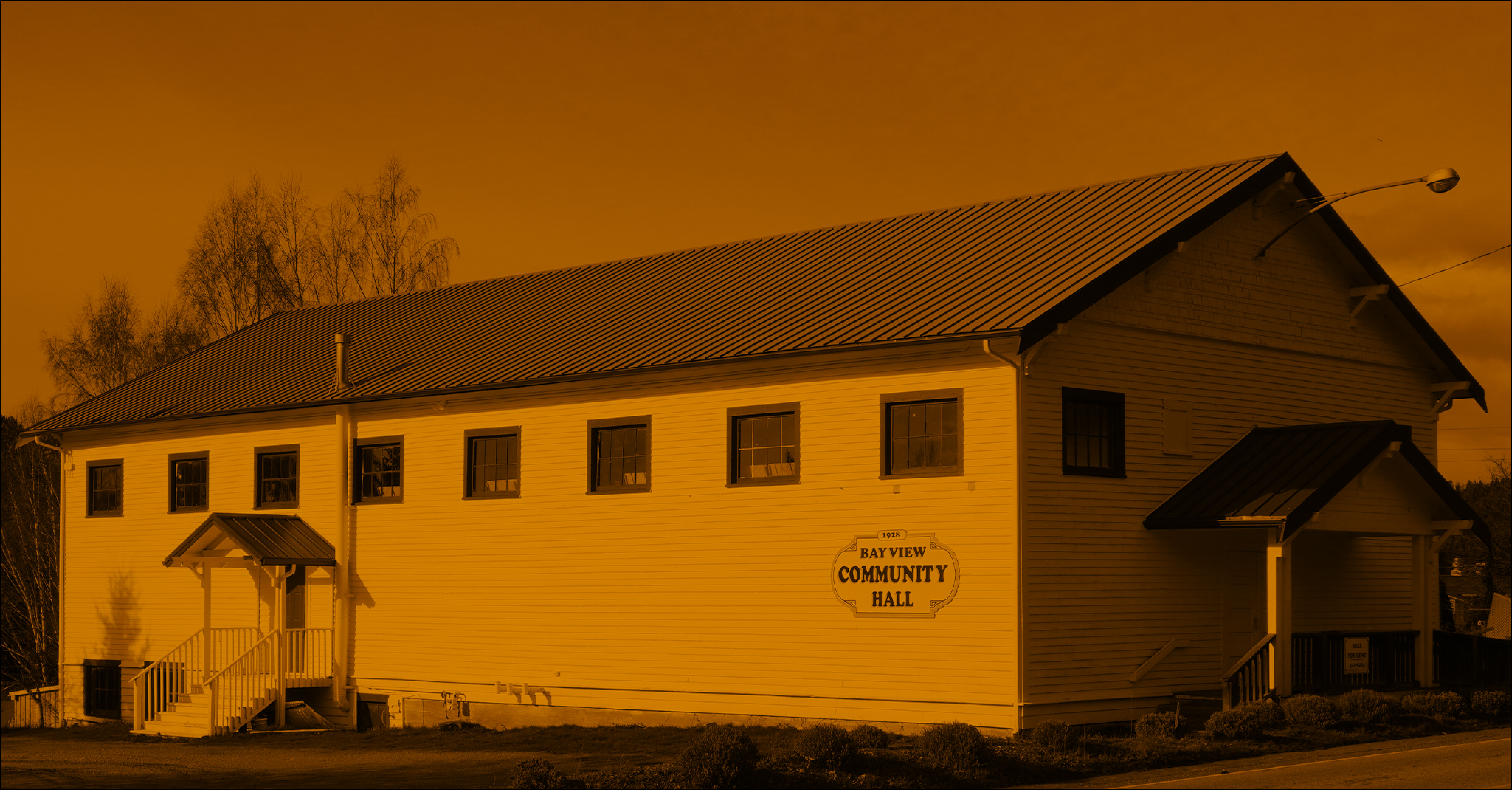 Duotone image of Bayview community hall in orange and black.